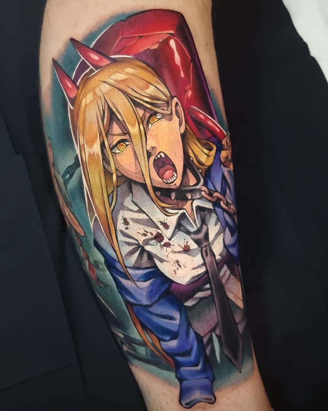 Colorful tattoo on an arm featuring a blonde anime character with red horns, wearing blue and white clothing with blood splatter details and a red cape.