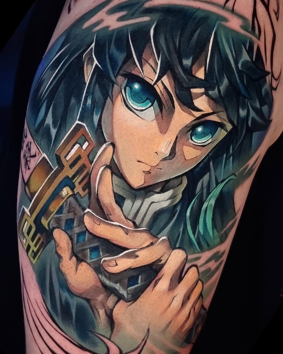 Colorful shoulder tattoo of an anime character with dark hair and turquoise eyes holding a mechanical weapon, featuring teal, brown, and skin-tone colors.