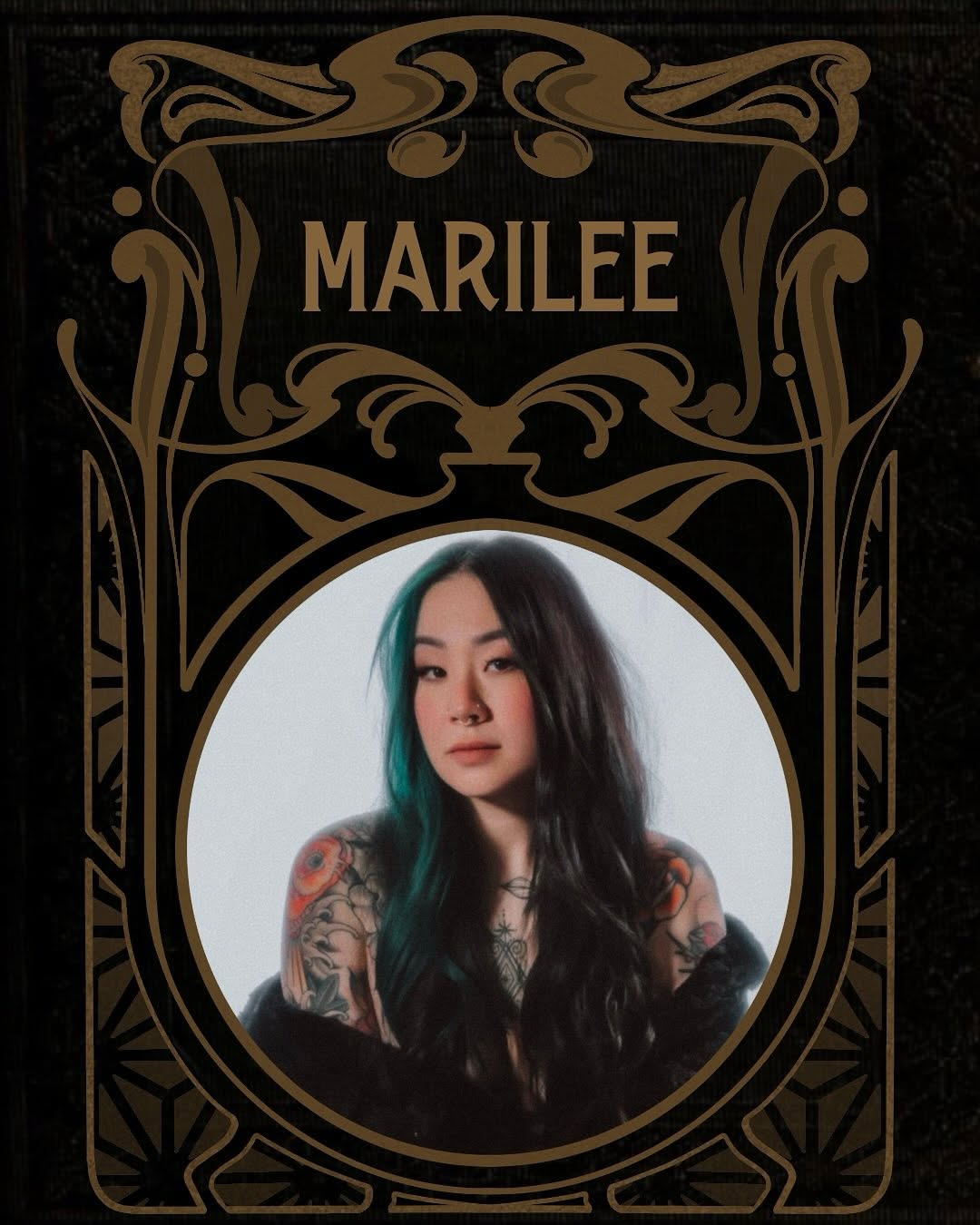 Portrait of a woman with long dark hair and teal streaks displaying colorful floral and geometric tattoos on both shoulders and arms.