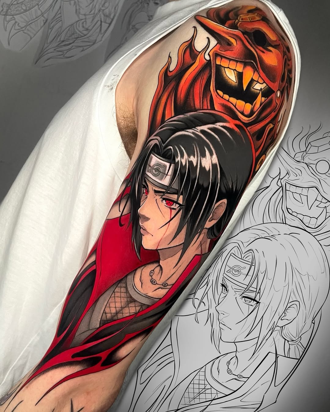 Colorful tattoo sleeve featuring an anime character with black hair and red eyes wearing red clothing, with a demonic red face above, surrounded by sketch designs.